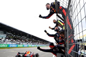 The Aston Martin Red Bull team greets second-place Max Verstappen Sunday at the Nurburgring