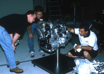Representatives from aftermarket performance parts companies inspect the engine of the new 2001 Acura RSX at American Honda's R&D facilities in Torrance, California.
