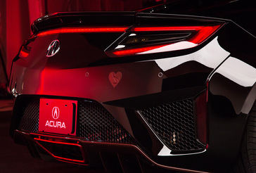 Custom MusiCares NSX featuring red accents on the lower diffuser, smoke tinted taillights and a custom MusiCares logo