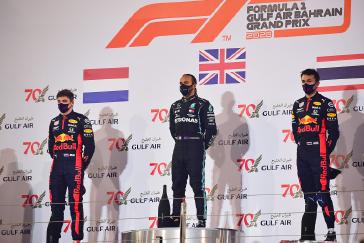 Aston Martin Red Bull drivers Max Verstappen (left) and Alex Albon (right) stood on the podium with race winner Lewis Hamilton after Sunday’s Bahrain GP