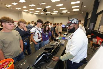 Students learn about forming and plastics from a Honda associate during MFG Day activities at the Marysville Auto Plant in Ohio