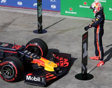 Max Verstappen gets out of his car after winning the pole Saturday for the Brazilian GP