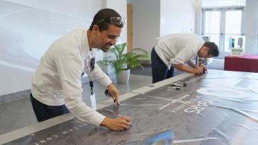 Associates marked two decades of excellence, continued innovation, and commitment to the Piedmont Triad community with a commemorative banner signing.