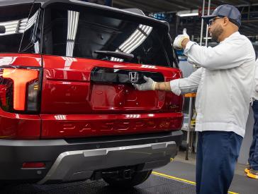 A Honda associate in the Alabama Auto Plant makes a final check of the Honda Passport, ranked 10th in this year’s Cars.com American-Made Index