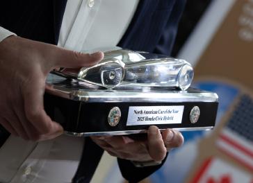 American Honda Zone Manager Josh Beckner holds the 2025 North American Car of the Year™ trophy for the NACOTY award-winning 2025 Honda Civic Hybrid, in Detroit on January 10, 2025.