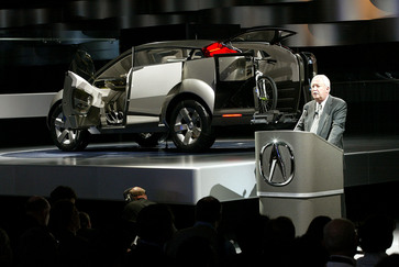 Tom Elliott, executive vice president of American Honda, unveils the Acura RD-X SUV concept at the 2002 North American International Auto Show.  Powered by a 250-horsepower gas-electric hybrid engine, the RD-X features sliding doors and a transformable interior.