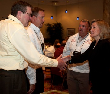 Jan Gansheimer, senior manager of purchasing at Honda of America Mfg., Inc., and John Aler from packaging planning in Honda purchasing, talk with August Finet, left, and Chad Bold from Woodruff Corp., Richmond, Ind. Woodruff is among six companies receiving the Supplier of the Year Award for excellence in providing services to Honda manufacturing plants in Ohio and Indiana.