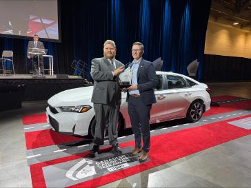 Nathan Muir, Senior Manager of Honda Sales and Marketing, receiving the 2025 Canadian Car of the Year award for the Honda Civic Hybrid.